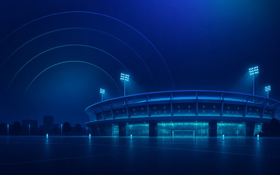 Floodlit stadium at night with wireless coverage across the bowl